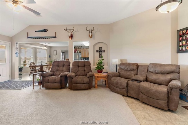 carpeted living room with ceiling fan and lofted ceiling