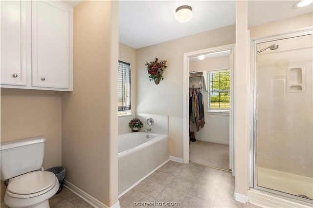 bathroom featuring toilet and independent shower and bath