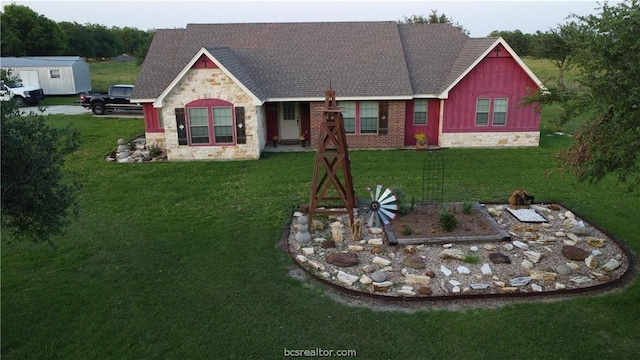 view of front of property with an outdoor structure and a front lawn