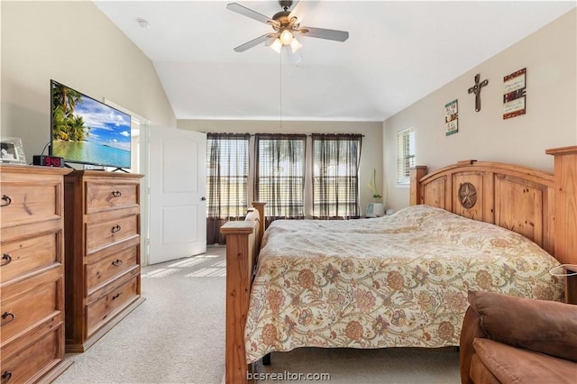 carpeted bedroom with ceiling fan and lofted ceiling