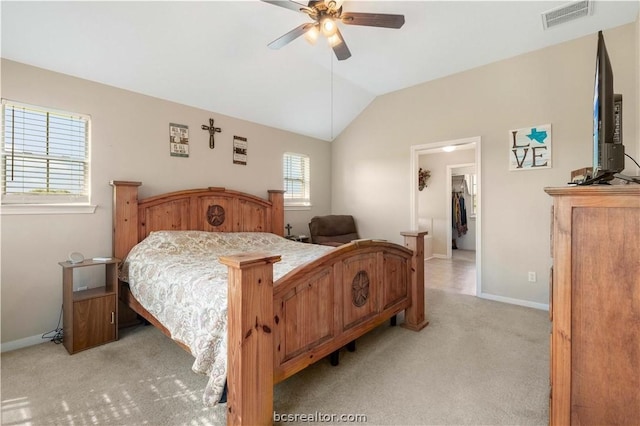 bedroom with light colored carpet, ceiling fan, a spacious closet, a closet, and lofted ceiling