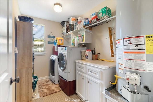 washroom featuring water heater, light tile patterned flooring, and washer and dryer