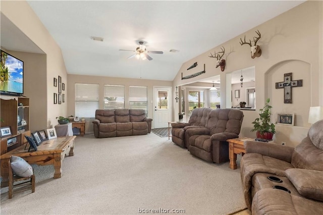 living room featuring carpet flooring, ceiling fan, and vaulted ceiling