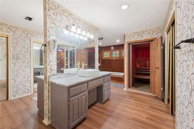 1309 Rock Dam Rd, Marlin, TX 76661 - bathroom with vanity, wood finished floors, and wallpapered walls