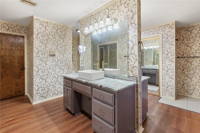 1309 Rock Dam Rd, Marlin, TX 76661 - bathroom with ornamental molding, baseboards, wood finished floors, and wallpapered walls