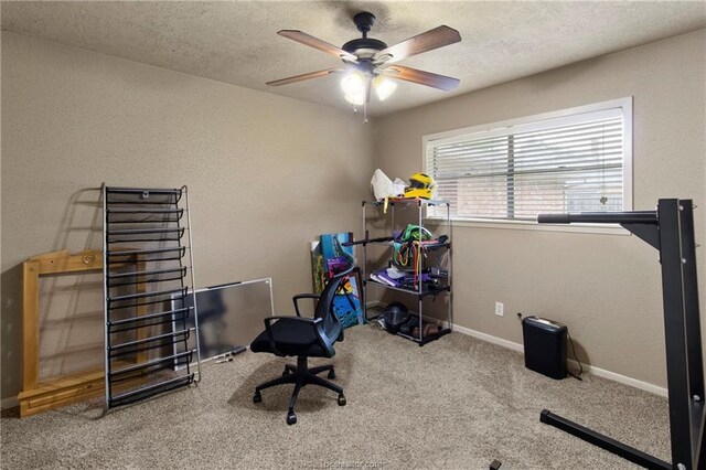 home office with ceiling fan, carpet floors, and a textured ceiling