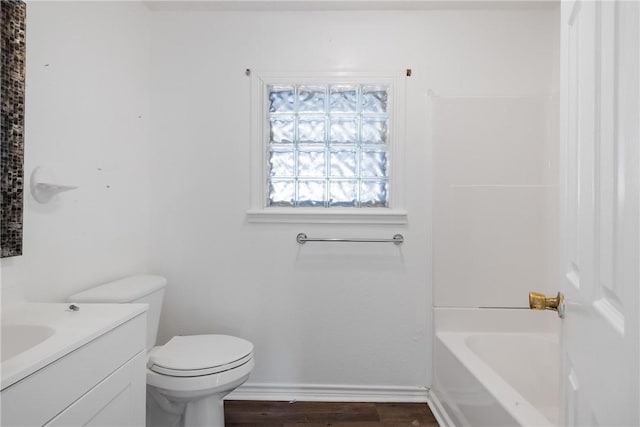 bathroom featuring toilet, wood-type flooring, and vanity