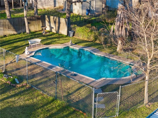 view of pool with a lawn