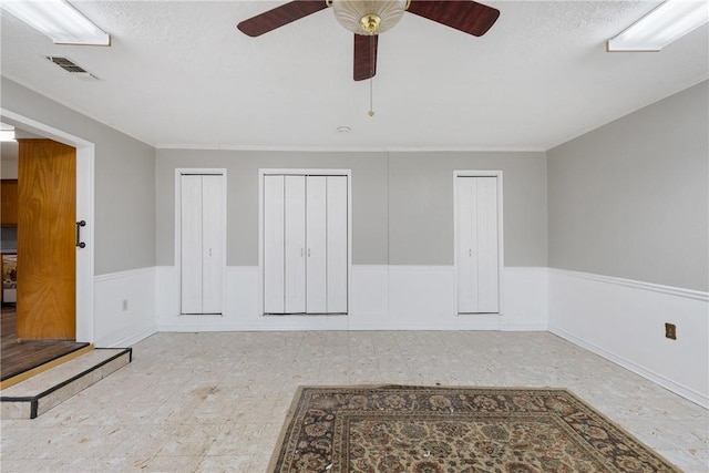 interior space with ceiling fan