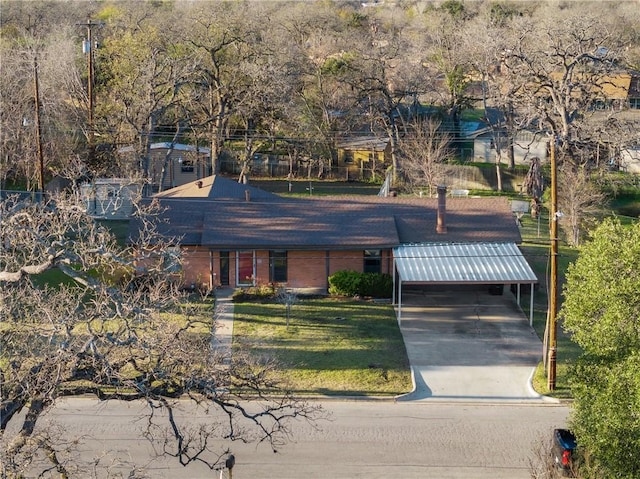 view of front facade featuring a front lawn and a carport