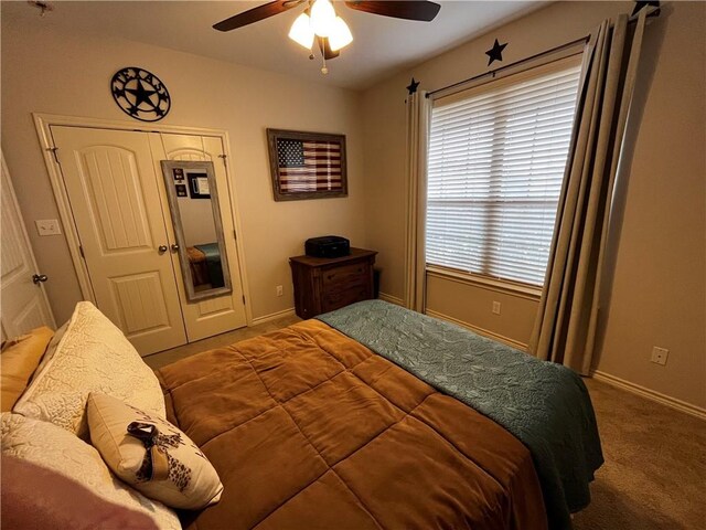 carpeted bedroom featuring a ceiling fan, a closet, and baseboards