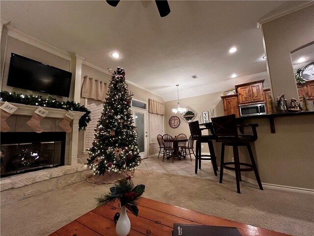 living area with light carpet, a fireplace, crown molding, and recessed lighting
