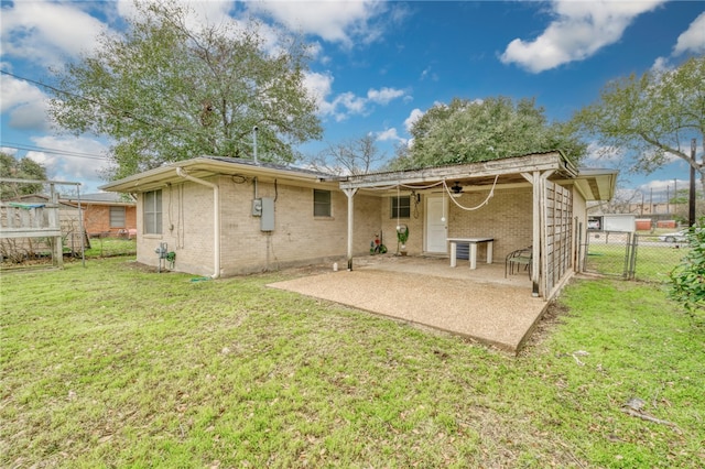 rear view of house with a patio area and a lawn