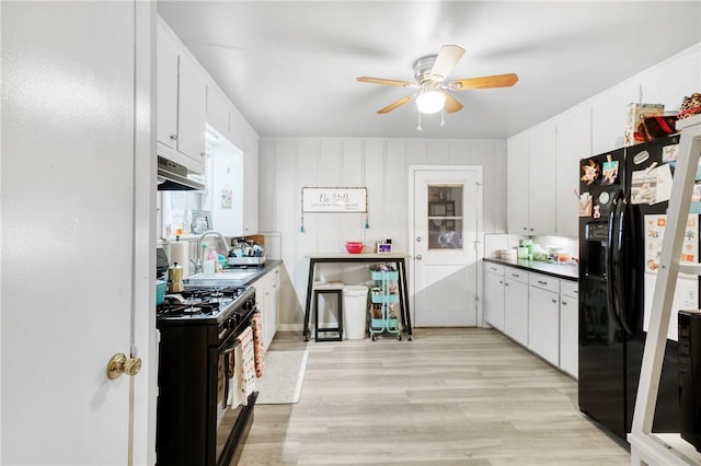 kitchen featuring sink, white cabinetry, light hardwood / wood-style flooring, ceiling fan, and black appliances