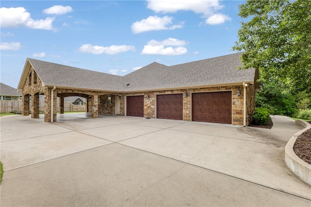 4675 River Garden Ct, Bryan, TX 77808 - view of front of house with stone siding, driveway, and roof with shingles