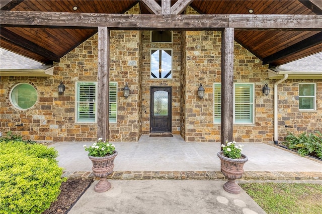 4675 River Garden Ct, Bryan, TX 77808 - view of exterior entry featuring stone siding and a patio area