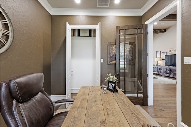 4675 River Garden Ct, Bryan, TX 77808 - home office featuring a textured wall, wood finished floors, ornamental molding, and recessed lighting