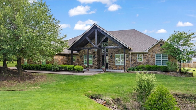 4675 River Garden Ct, Bryan, TX 77808 - rear view of property with stone siding and a yard