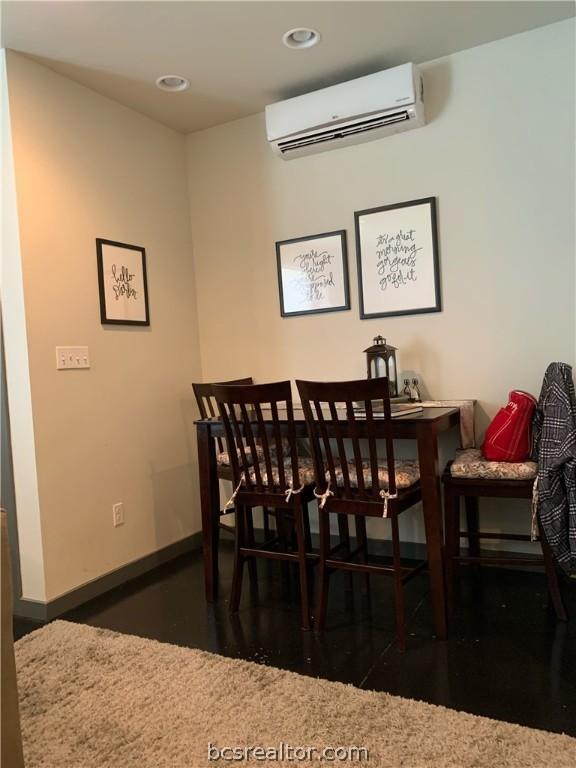 dining room featuring an AC wall unit