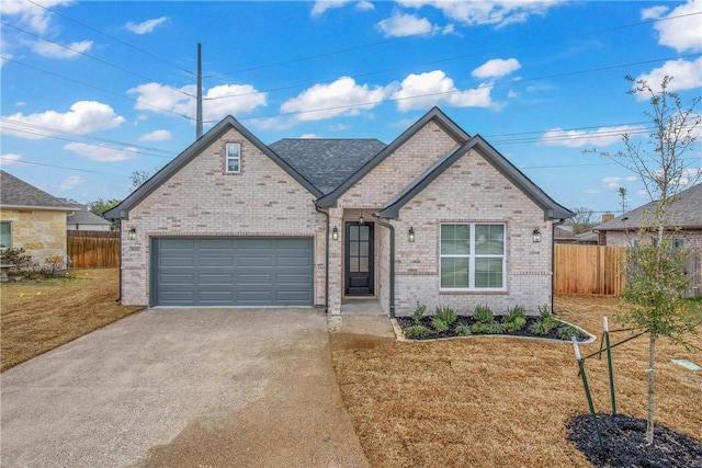 view of front facade featuring a garage, concrete driveway, brick siding, and fence