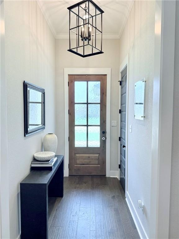 4203 Lismore Ln, College Station, TX 77845 - doorway to outside featuring ornamental molding, a chandelier, dark wood-type flooring, and baseboards