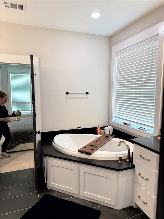 4203 Lismore Ln, College Station, TX 77845 - bathroom featuring ensuite bathroom, a garden tub, tile patterned floors, and recessed lighting