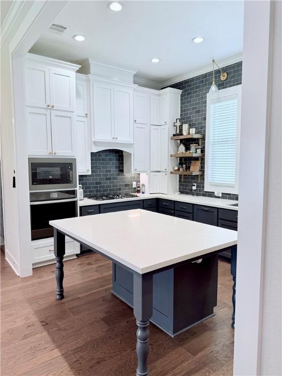 4203 Lismore Ln, College Station, TX 77845 - kitchen featuring stainless steel oven, built in microwave, a breakfast bar, open shelves, and recessed lighting