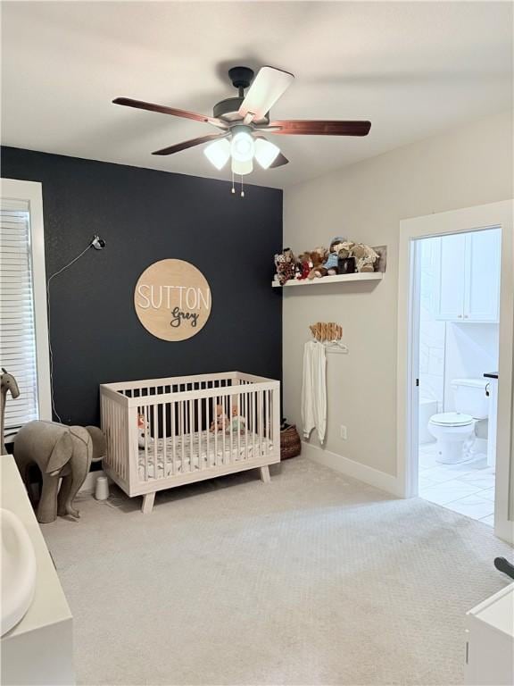 4203 Lismore Ln, College Station, TX 77845 - carpeted bedroom with a ceiling fan, a nursery area, connected bathroom, and baseboards
