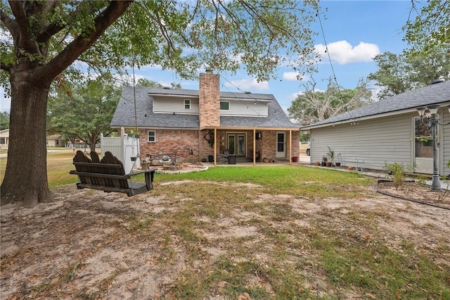 rear view of house with a yard