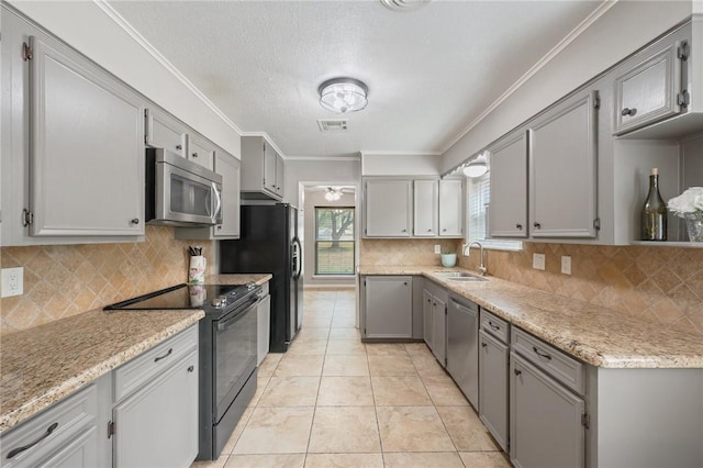 kitchen with tasteful backsplash, sink, black appliances, and ornamental molding