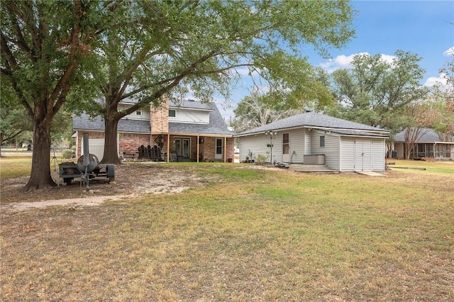 rear view of house with a yard