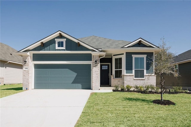 craftsman inspired home with a garage and a front lawn