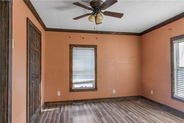 unfurnished room with ceiling fan, hardwood / wood-style floors, ornamental molding, and a textured ceiling