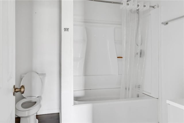 bathroom with toilet and shower / bathtub combination with curtain