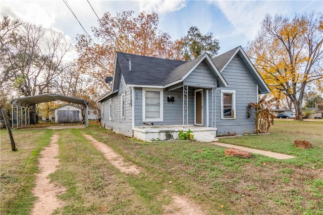 bungalow featuring a front lawn and a carport