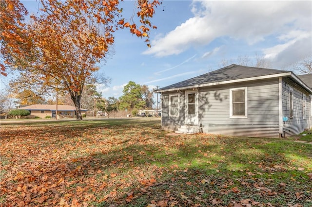 view of side of property with a yard