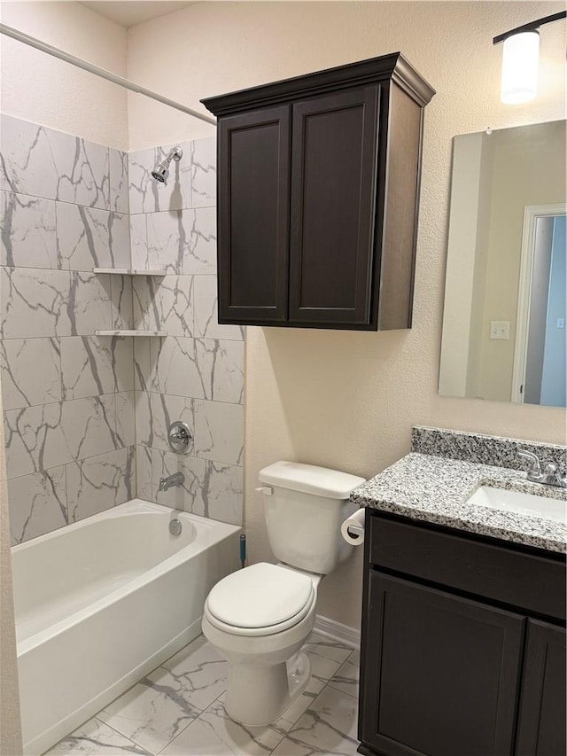 bathroom with washtub / shower combination, vanity, toilet, marble finish floor, and baseboards