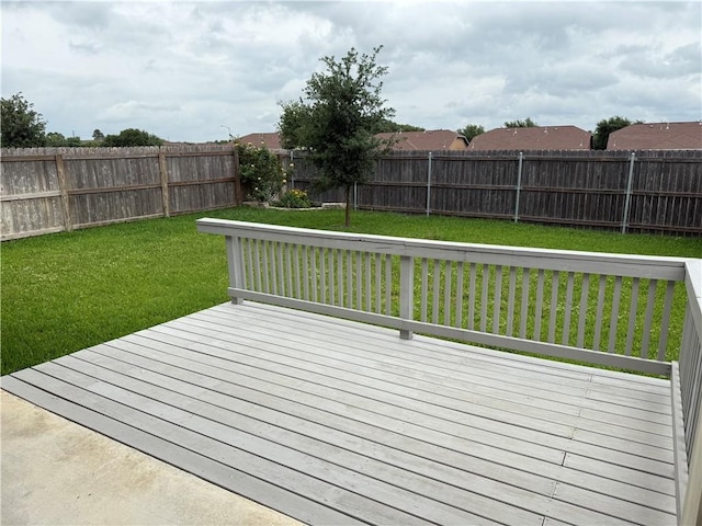 wooden terrace with a fenced backyard and a yard