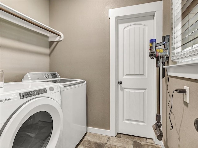 2102 Cary Cir, Bryan, TX 77803 - washroom featuring washing machine and dryer and stone finish flooring