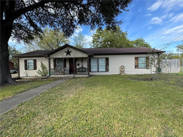 ranch-style house featuring a porch and a front yard