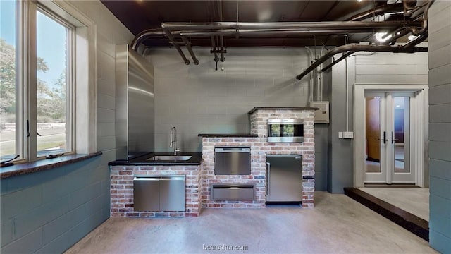 view of patio featuring french doors and sink