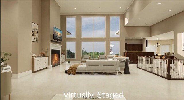 living room featuring a wealth of natural light, a high ceiling, and an inviting chandelier