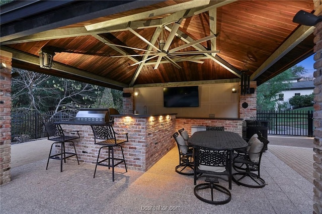 view of patio / terrace featuring a gazebo, area for grilling, and a bar