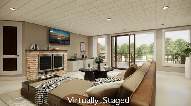 living room featuring a paneled ceiling, a brick fireplace, and bar area