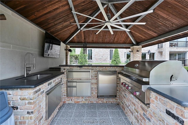 view of patio with a gazebo, area for grilling, a grill, and sink