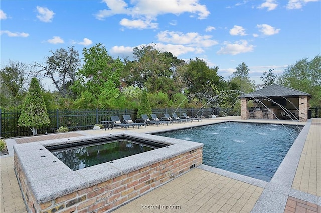 view of swimming pool featuring an in ground hot tub, a gazebo, pool water feature, and a patio area