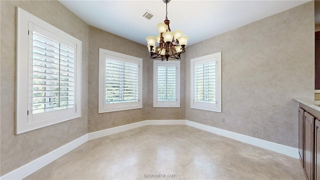 unfurnished dining area featuring an inviting chandelier and a wealth of natural light