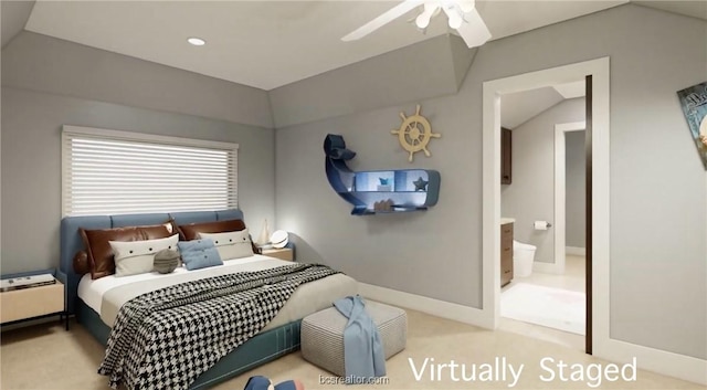 carpeted bedroom with vaulted ceiling, ensuite bath, and ceiling fan