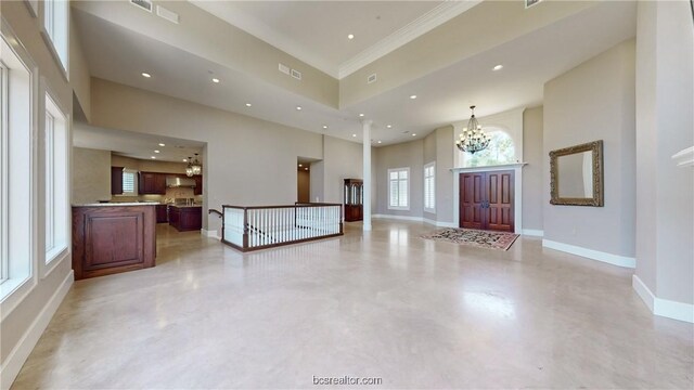 foyer entrance with a towering ceiling and a notable chandelier