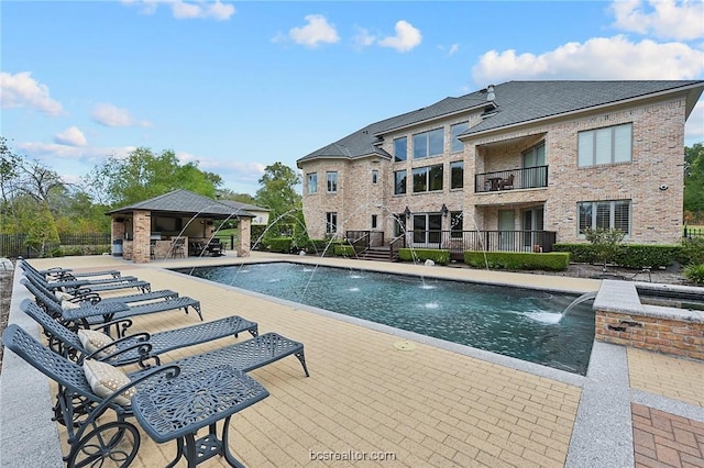 view of pool featuring pool water feature and a patio